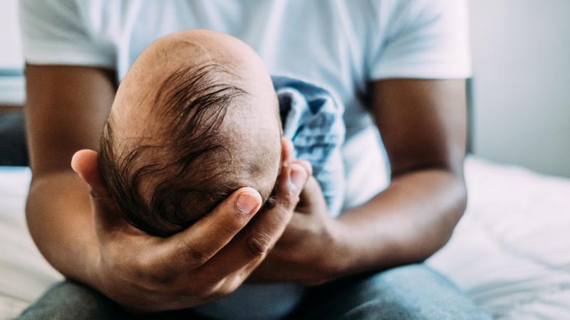 man holding an infant
