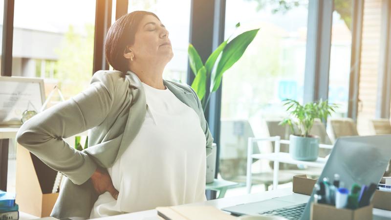 A woman rubbing her back.