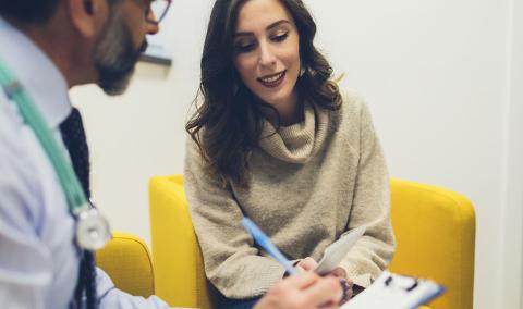 A woman speaking with a physician.