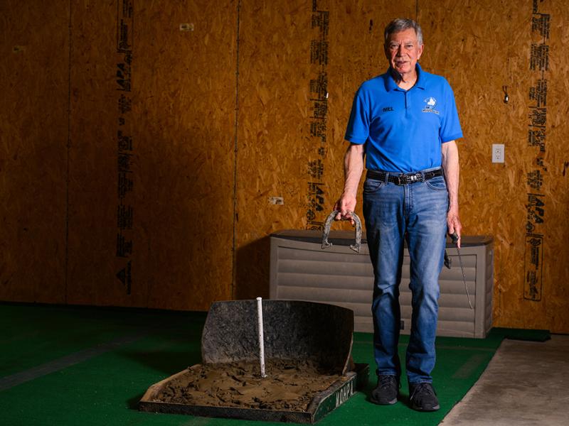 Mel holding a horshoe.