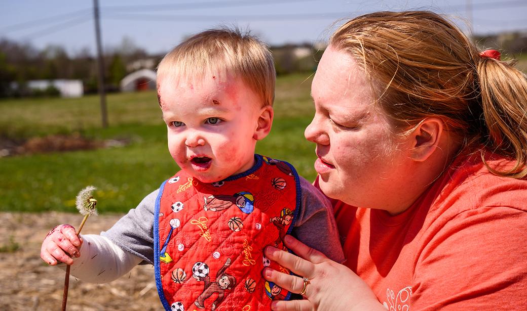 A photo of Matthew and his mother at the park.