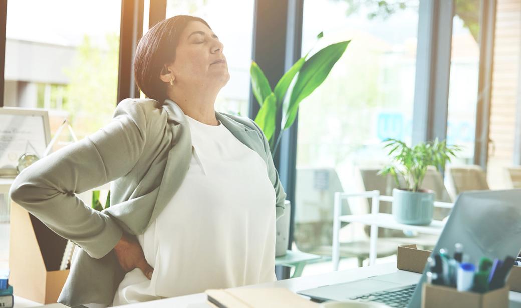 A woman rubbing her back.
