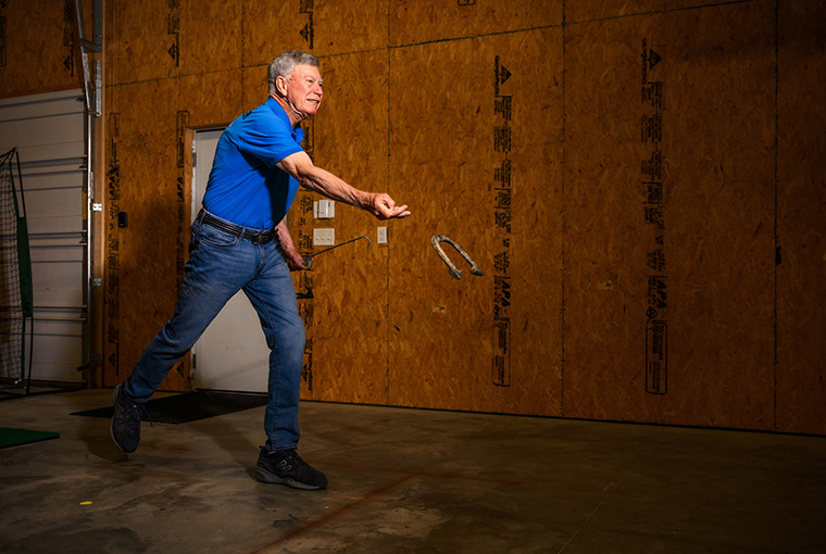 Mel Bruemmer pitches a horseshoe at his home in Jefferson City. A member of the Missouri State Horseshoe Pitching Hall of Fame, Mel regained his form after surgery at MU Health Care.