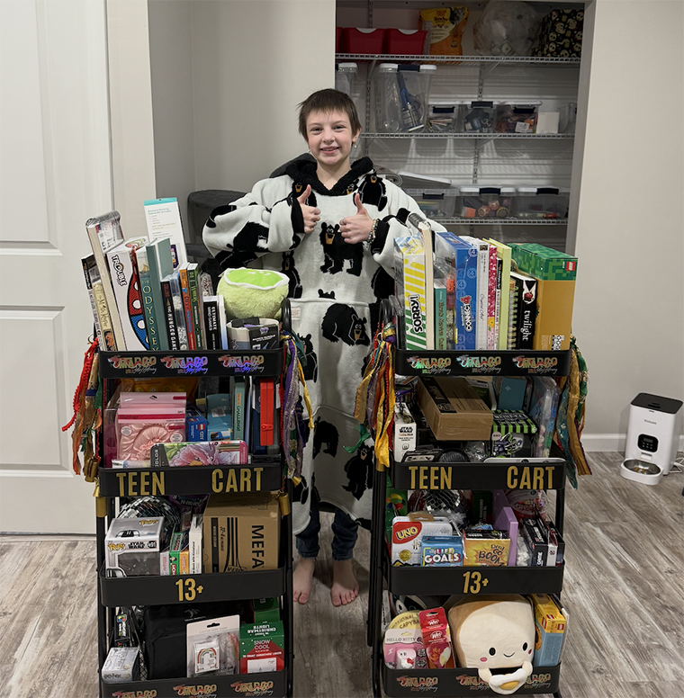 Margo poses with the teen carts she created for fellow Children’s Hospital patients.