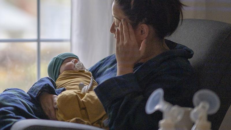 A mother holding her newborn child.