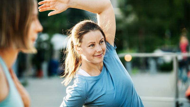 a woman stretching outdooors