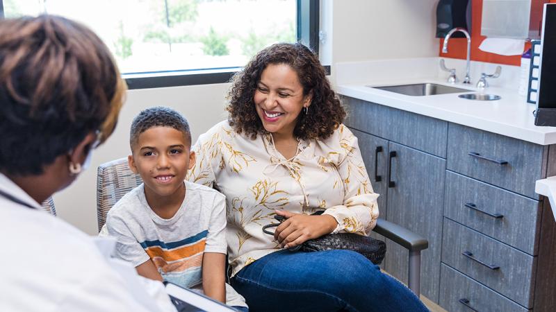 A mother and child speaking with a physician.